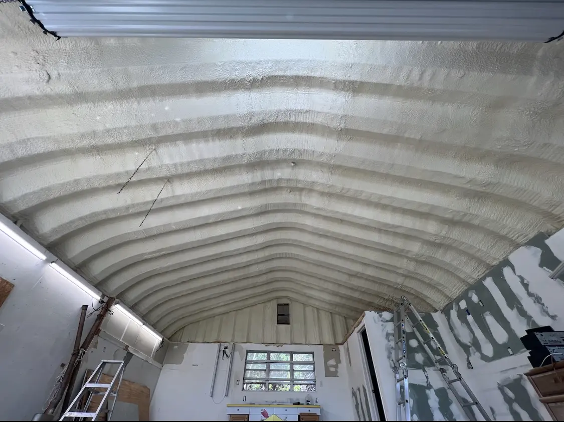 Spray polyurethane foam applied to the underside of a metal roof deck in Henrietta